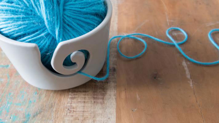gifts for yarn lovers phot of white yarn bowl with blue yarn 