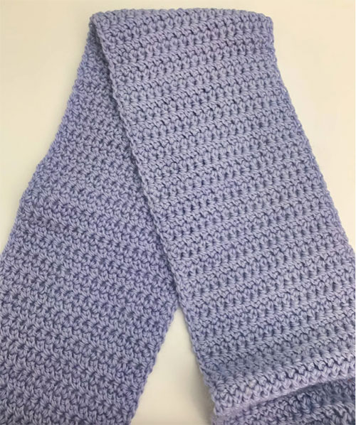 extended single crochet photo of scarf laid flat overlapping itself on a white background