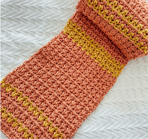 lexi lace photo of the scarf rolled up on a white background to showcase the stitch pattern 