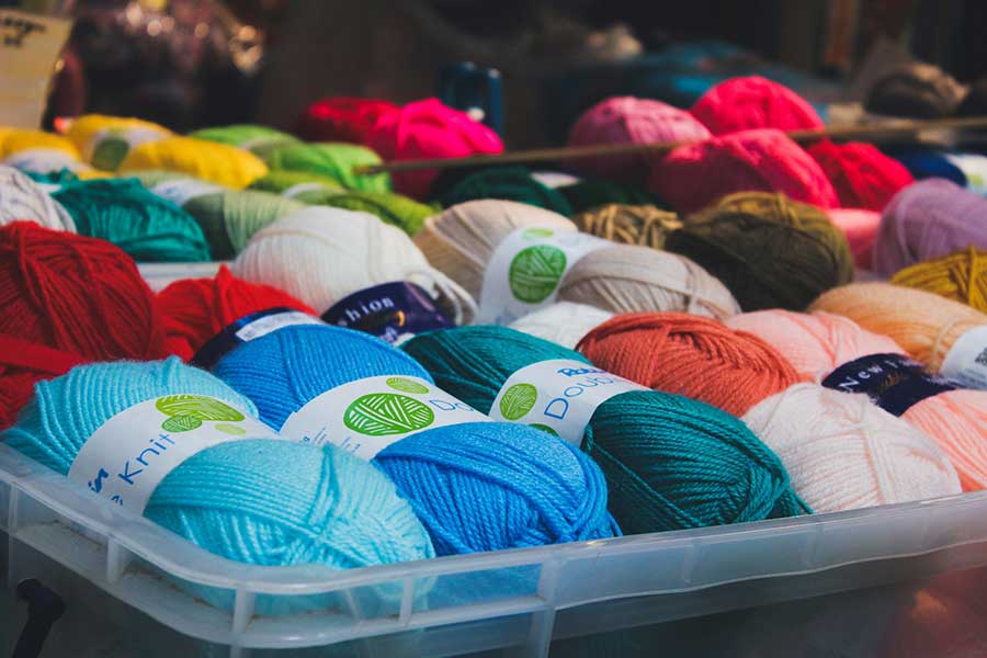 picture of colourful yarn in a plastic tote bin 