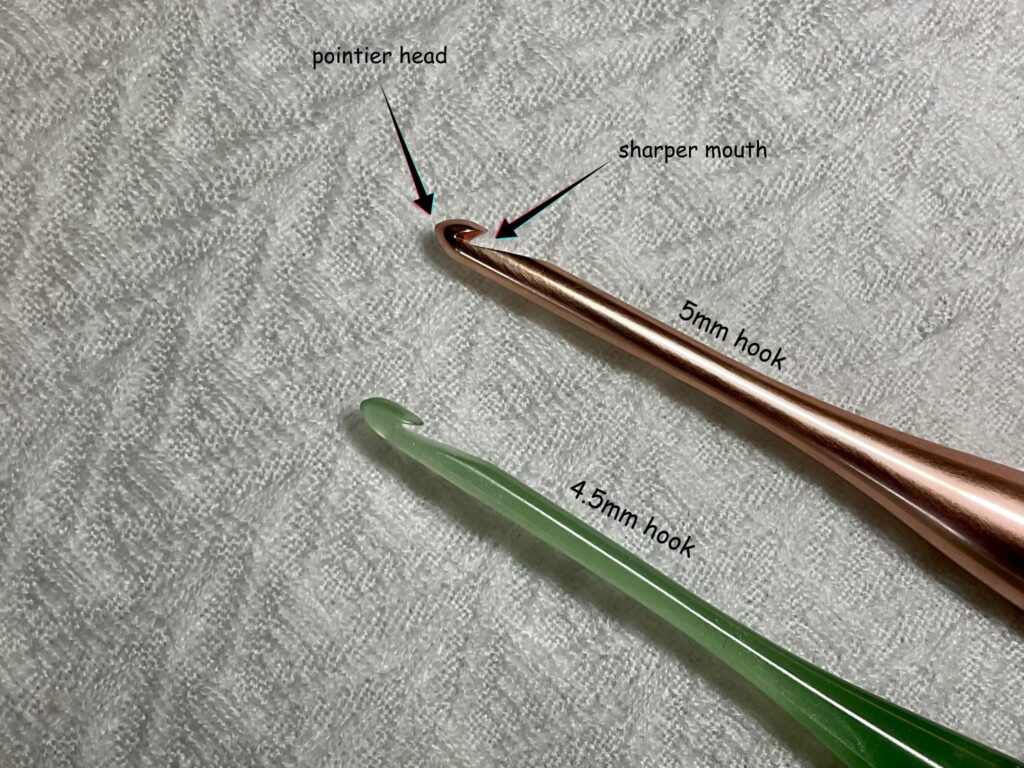 picture of two crochet hooks with text and arrows showcasing parts of a hook 