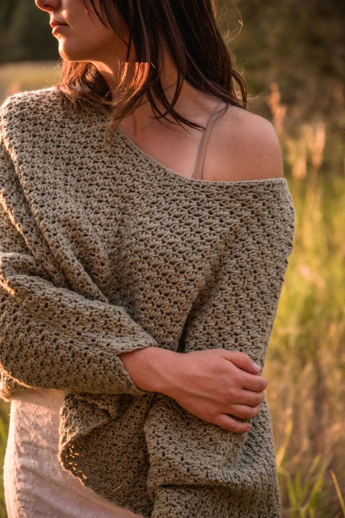 photo of a model wearing a brown crochet sweater 